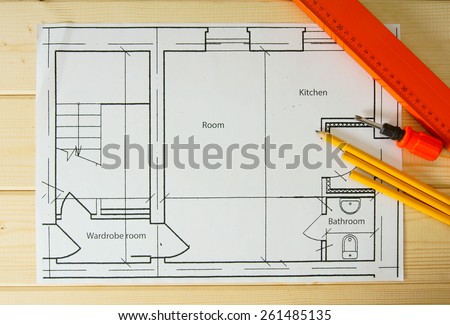 Planning of repair of apartment. Repair work. Drawings for building, helmet, pencils on wooden background.