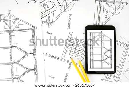 Planning of construction of the house. Tablet, drawings and working tools.