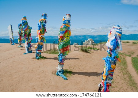 Buryat traditional pillars with colored ribbons by Lake Baikal (Olkhon Island, Russia).
