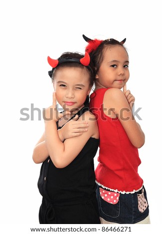 Scary cute little asian girl best friend in black and red Halloween costume.