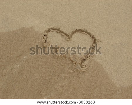 heart in sand with water