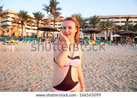 Beautiful woman on background of beach. Persian Gulf ,Dubai.Tanning girl near ocean, tropical resort, summer holiday