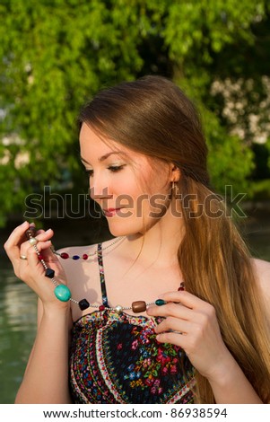 Portrait of the beautiful caucasian woman with long silky healthy hair on nature