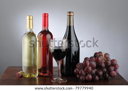 Still life of red wine, white, rose, glass of wine, grapes, bottle and cork