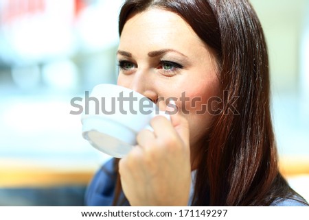 Closeup portrait of businesswoman drinking coffee in office cafe