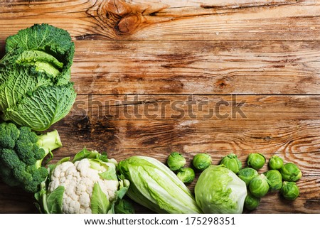 Fresh green  vegetables  on a rustic wooden table.