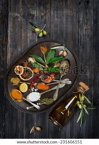 View from the top on olives, olive oil and spices composition on wooden