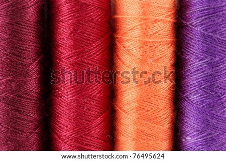 closeup of colorful threads dark red,red,orange,violet