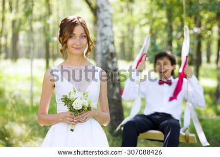 Happy lovely couple on their wedding day in the summer forest