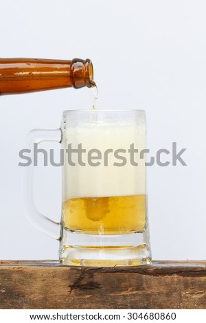 International beer day with pouring beer into glass on white background.