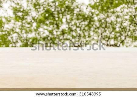 Blank wood table top with blurred bokeh background : Suitable montage or display your products.