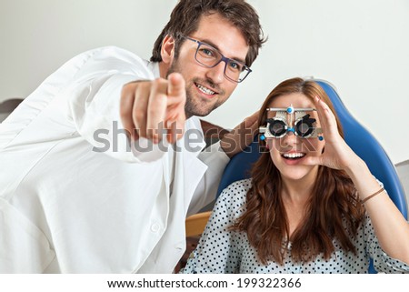Optometrist Giving Young Woman An Eye Examination