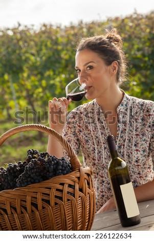 Beautiful Young Woman Drinking Wine In Vineyard