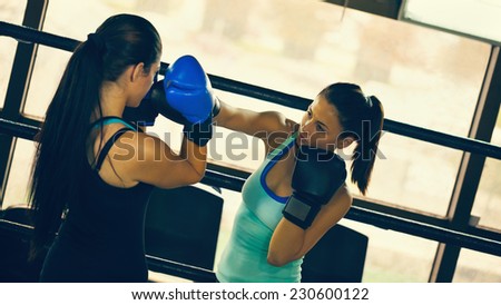 Two Female Boxers At Boxing Ring Fighting