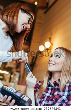 Beautiful Waitress Charging Customers Bill With A Credit Card Terminal