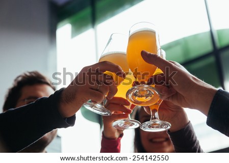 Group Of Friends Toasting In Tavern