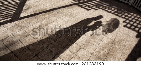 Shadow Of Lovely Marriage Couple Embracing Outdoors with umbrella.