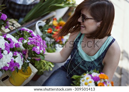 Beautiful Young Woman Choosing Flowers At The Florist Shop
