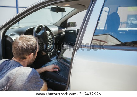 Auto Mechanic Doing Diagnostic Test
