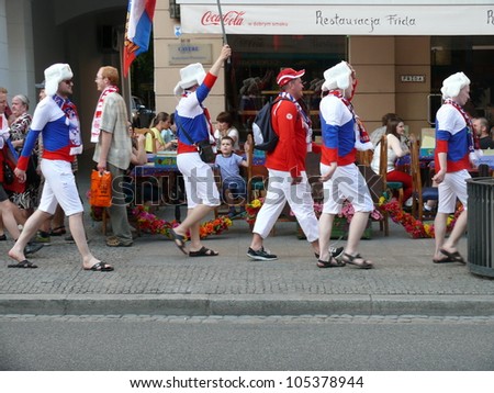 WARSAW, POLAND - JUNE 16: Russian national football team fans going through Nowy Swiat to the National Stadium to see UEFA EURO 2012 football match vs. Greek team, June 16, 2012 in Warsaw, Poland