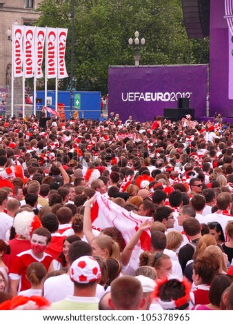 WARSAW, POLAND - JUNE 16: Thousands of Polish fans gathered in Fanzone, to support national team minutes before UEFA EURO 2012 football match vs. Czech team, June 16, 2012 in Warsaw, Poland