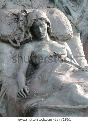 Old, religious art at Cimitero Monumentale. Scene sculptured on a grave depicts a young female sleeping in her bed, holding a cross. Milan, Italy. More of this motif & more Milan in my port.