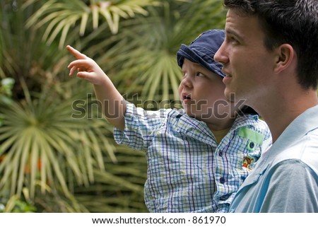 child pointing i amazement with young father