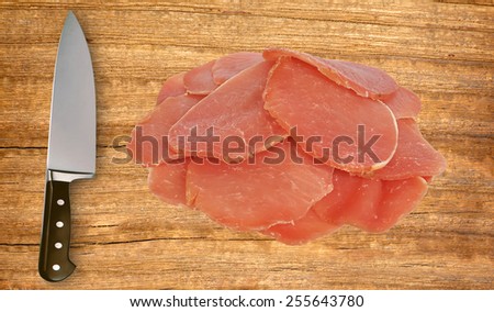 knife and meat on cutting board isolated on white background
