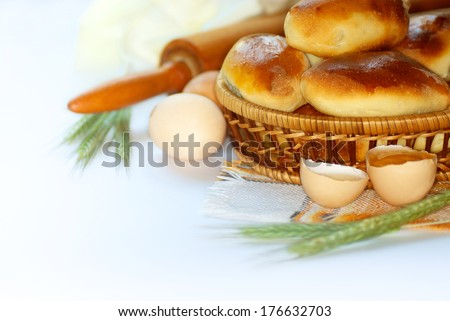 Fresh ingredients for baking (eggs, flour, wheat ears) and pastries in the form of cakes. On a white background. homemade food