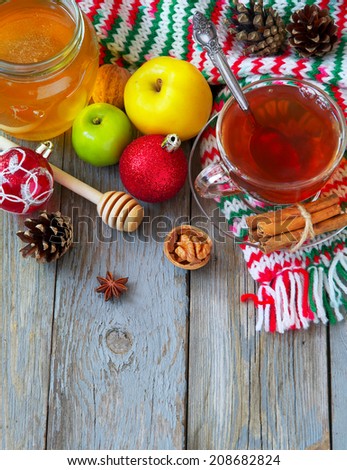 Christmas background. Christmas card family comfort. Homeliness. Tea with honey, fruits and nuts.
