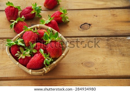 Ripe strawberries on an old wooden table.  Harvest berries