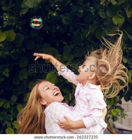 Mom and daughter playing with air bubbles