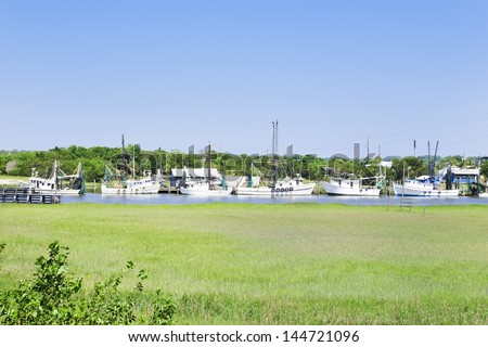 A fleet of southern fishing boats moored at their home dock on a sheltered waterway on the East coast.