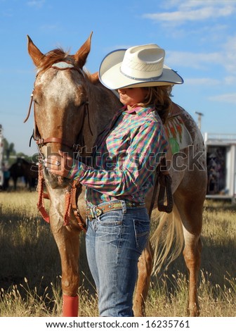 A young barrel racer spends a quiet moment with her horse before the competition.