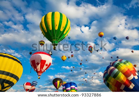 SAINT-JEAN-SUR-RICHELIEU, QUEBEC, CANADA - AUG. 16: Dozens of colorful hot air balloons take flight at the International Hot Air Balloon Festival of Saint-Jean-sur-Richelieu on August 16, 2011 in Saint-Jean-sur-Richelieu, Quebec, Canada.