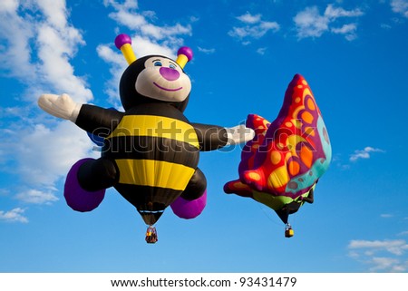 SAINT-JEAN-SUR-RICHELIEU, QUEBEC, CANADA - AUG. 16: Hot air balloons called Baby Bee and Betty Jean the Butterfly take flight at the International Hot Air Balloon Festival of Saint-Jean-sur-Richelieu