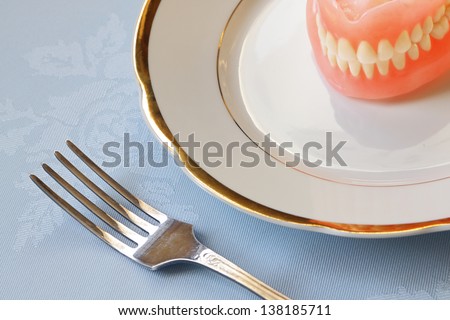 False teeth on  china ware with golden edging