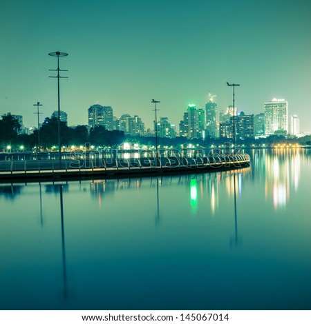 City at night with reflection of skyline,Vintage tone