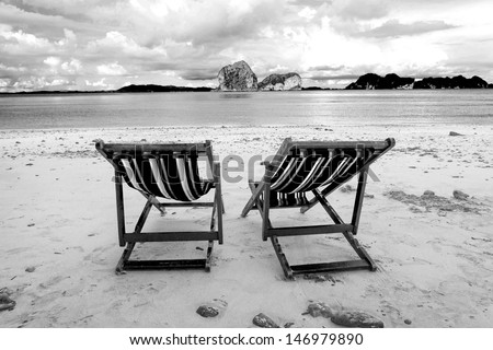 Beach chairs and beautiful beach on black and white tone