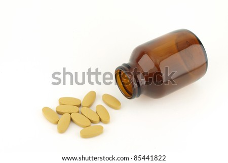 Pills spilling from bottle isolate on white background