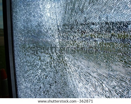 smashed shattered glass window pane gunshot cracks shards splinters pattern