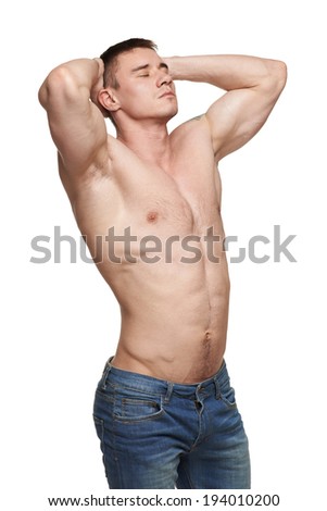 Muscular man posing in studio with hands over head, over white background