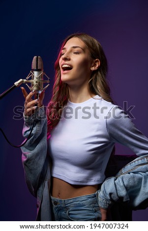 Similar – Image, Stock Photo Young woman singing with a microphone