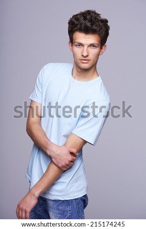 Handsome man in blank blue t-shirt with modern haircut