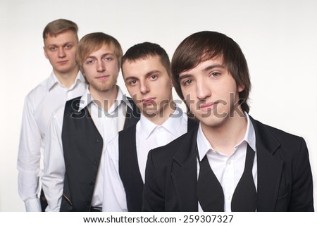 Portrait of a group of young men standing in line. Shallow depth of field, focus on the front male.
