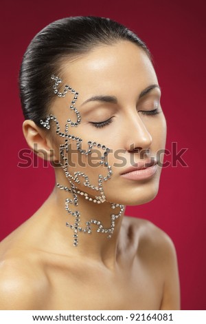 Portrait of female with beauty crystal puzzle on her face