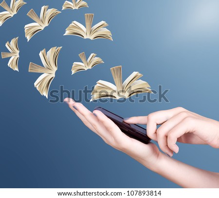 Hand holding modern mobile phone and open books flying away. Education concept
