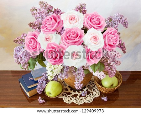 Sill life with roses and lilac flowers bunch,apples and books on artistic background