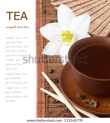 Asian Tea breakfast (still life with tea cup, flower and fan leaves isolated on white background with sample text)