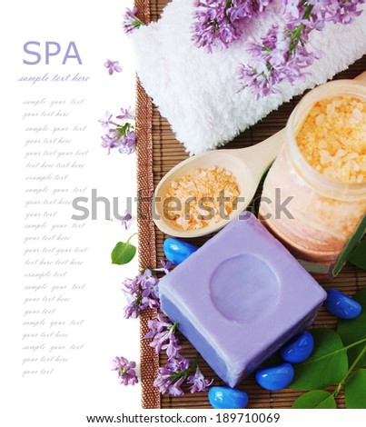 Spa composition with beautiful lilac flowers over white with sample text